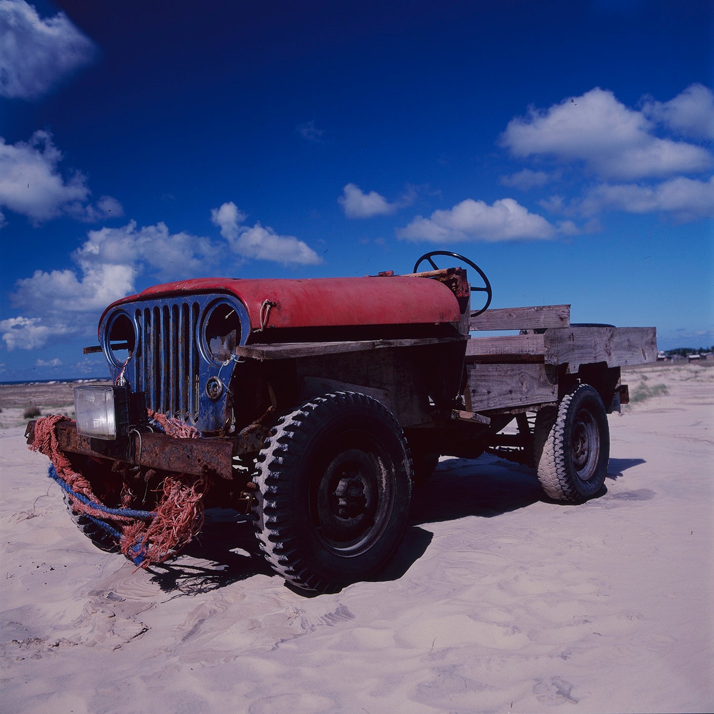 Wooden Machines

Photographed in April 2001 on the coast of Mostardas, Rio Grande do Sul, Brazil, these images reveal extraordinary vehicles created by local artisanal fishermen to confront the sea, sand and corrosive salt air.

Old four-wheel-drive vehicles had their original metal bodies replaced by wooden structures, adapted for the demanding daily work of pulling heavy fishing nets from the ocean. Built outdoors with necessity, experience and remarkable ingenuity, these machines possess a singular beaut