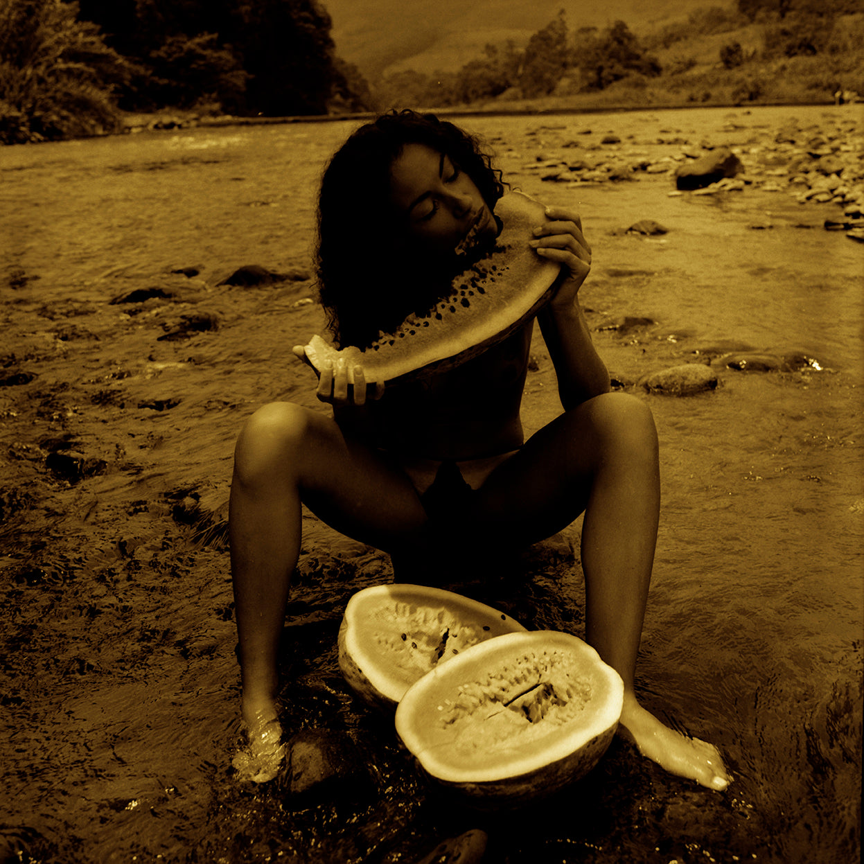 This process creates a vibrant dialogue between the timeless strength of the original photograph and a contemporary painterly atmosphere. Captured at the Mampituba River in southern Brazil, with its clear water, smooth stones, and natural light, the work celebrates the body in harmony with nature. It is an original fine art photograph designed for large-format printing, ideal for collectors seeking poetic, luminous, and distinctive contemporary photography.